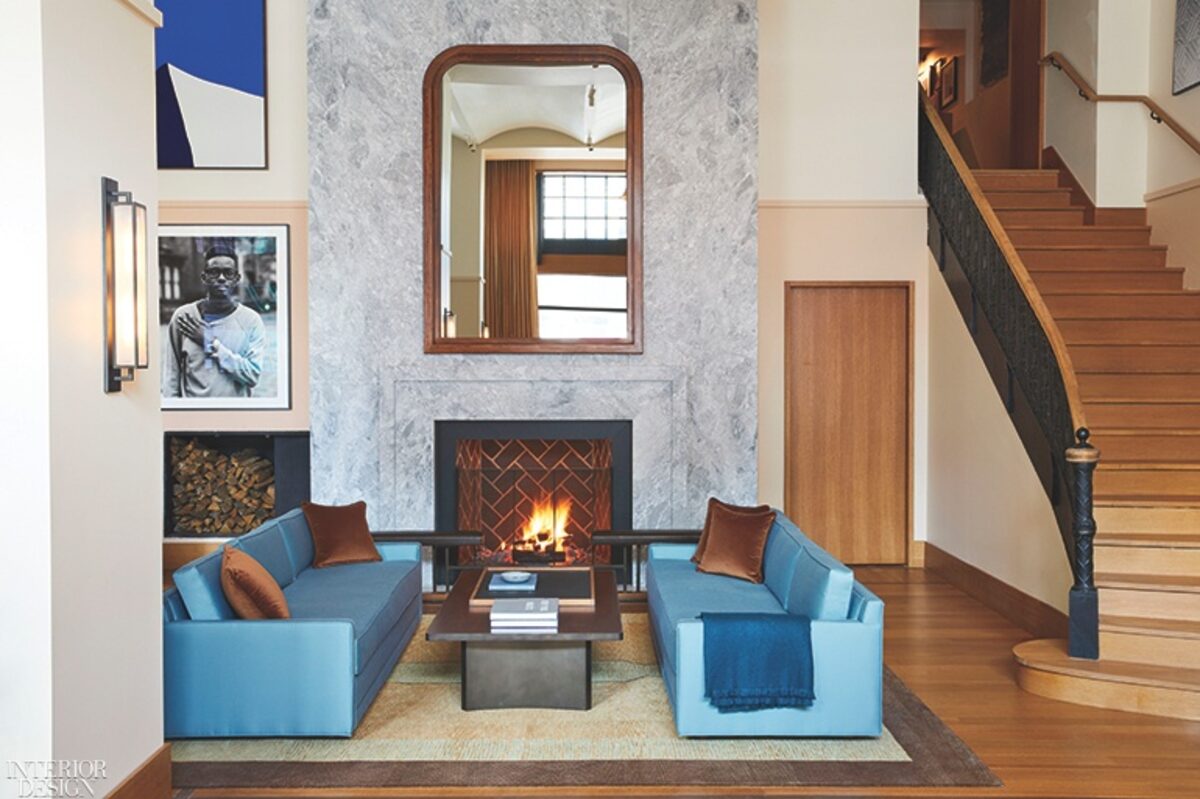 Hotel lounge with a fireplace and blue armchairs